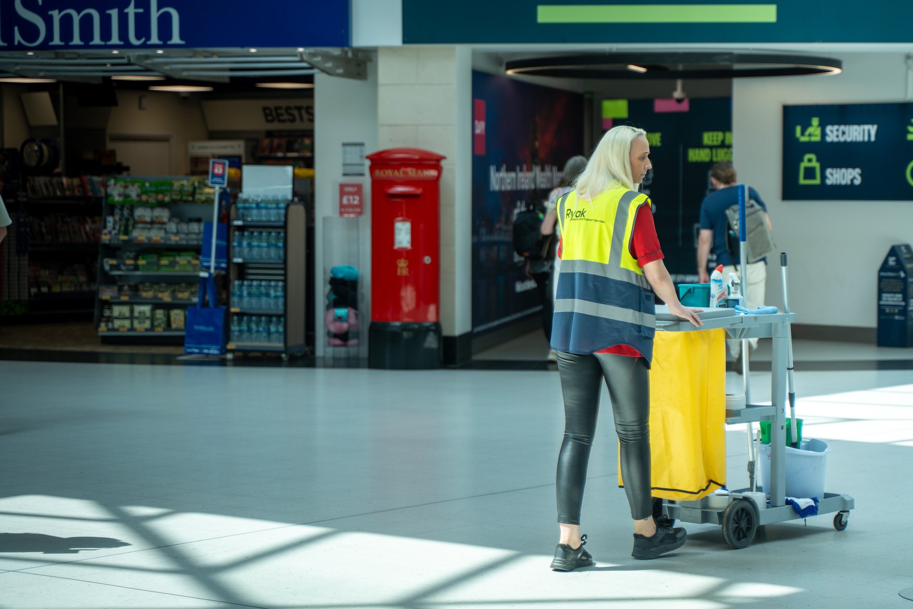 Ryak cleaning operative with branded trolley in a commercial facility